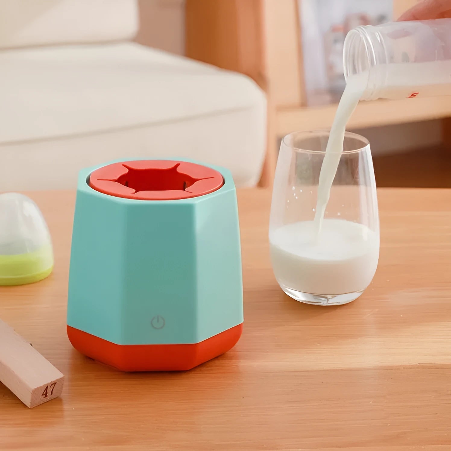 White baby electric milk shaker with silicone slot holding a baby bottle on a table, 110x110x110mm size