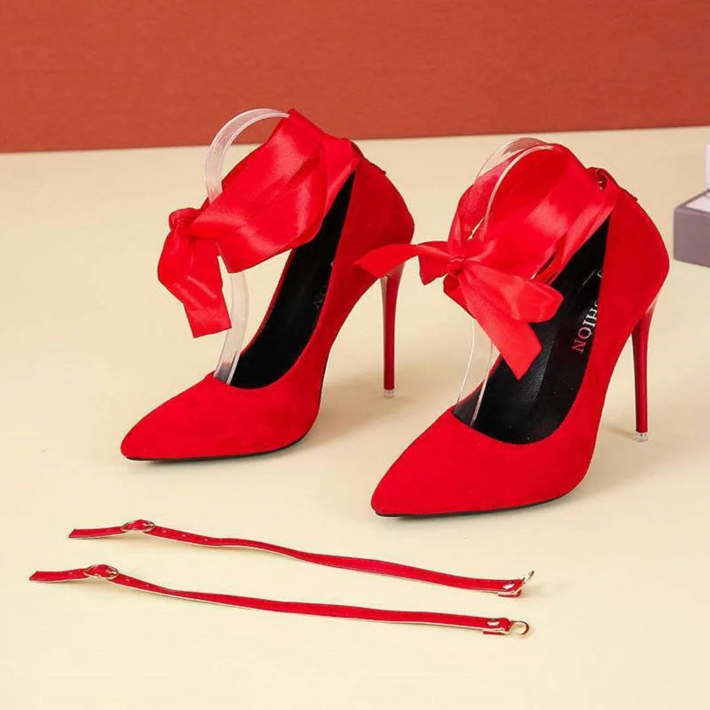 Women's black pointed toe stiletto heels with a thin shallow mouth and lace ankle strap.