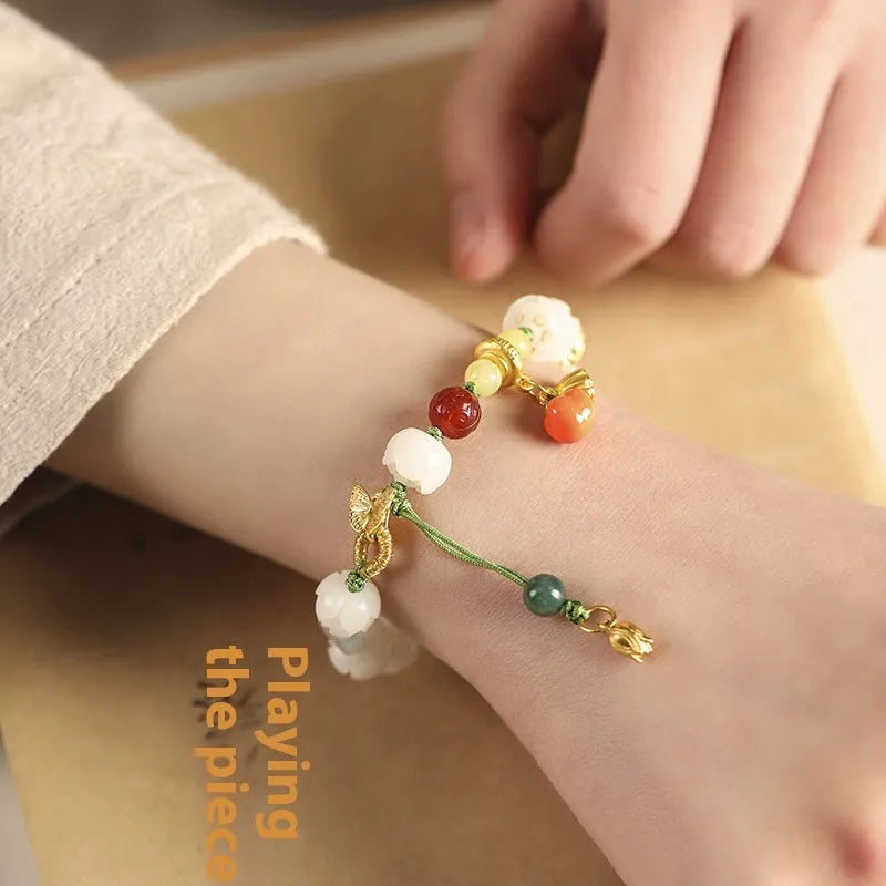 Hand-woven white jade bodhi bracelet with lotus and large pumpkin beads on a single ring open rope.