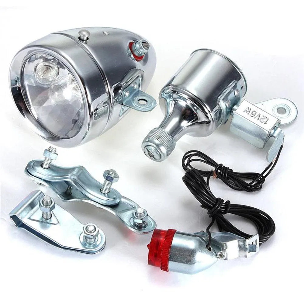 Silver bicycle dynamo-powered generator light kit for mounting on frame, showing wiring connectors.