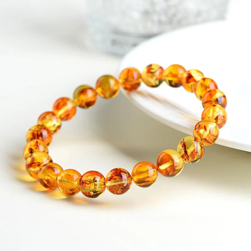 Natural yellow piebald amber bracelet with flower spot patterning and geometric design