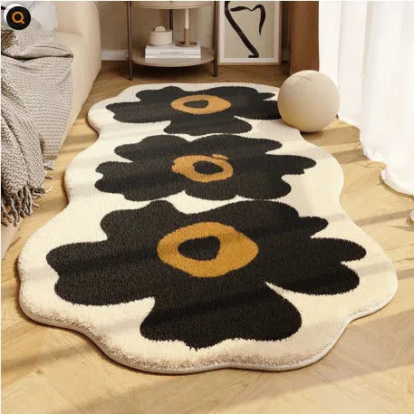 Flower-shaped blanket with printed cartoon floral design in green and white colours, laid flat.