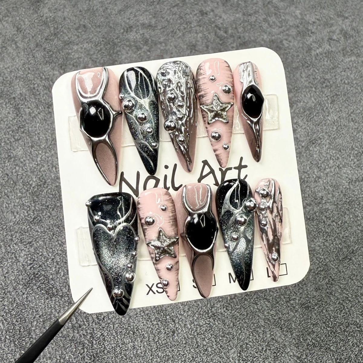 Long pointed press-on false nails with embossed relief and hand-painted metal detail in XS S M L sizes