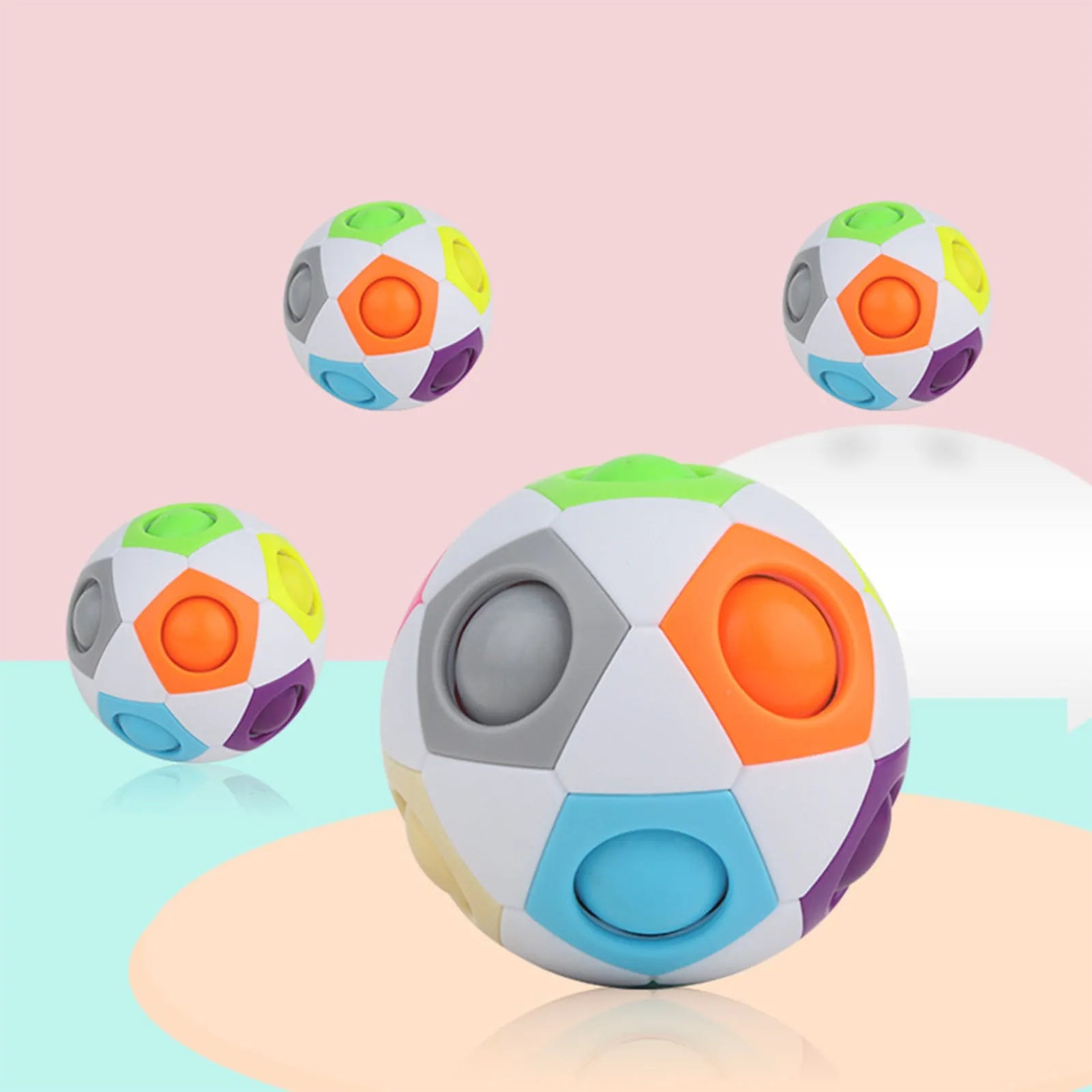 Colourful rainbow ball puzzle toy with visible holes, 5.5 cm in diameter.