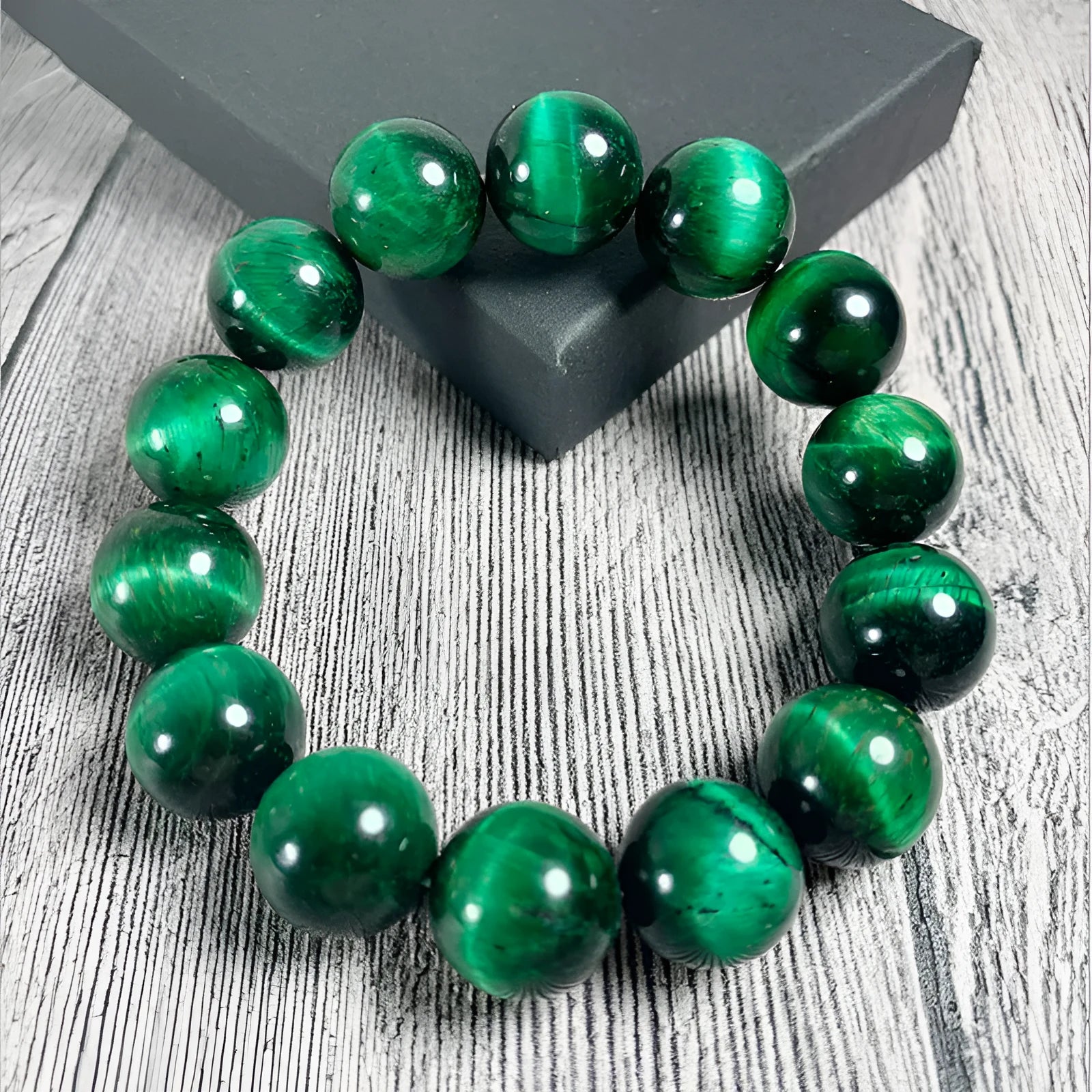Green Tiger Eye stone bracelet with round polished beads on a wrist.