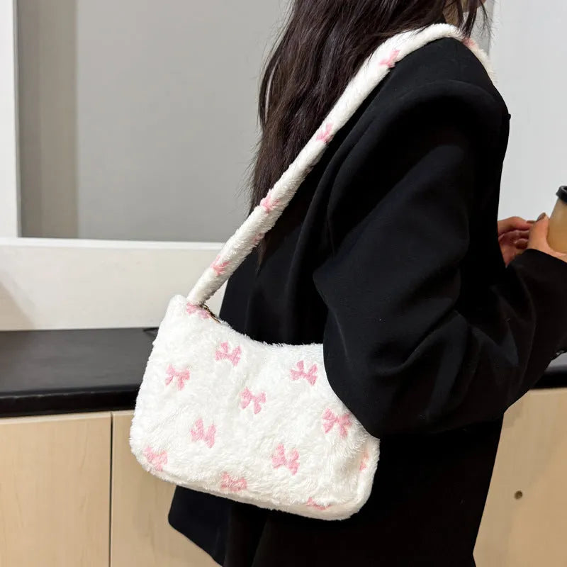 Contrast colour fur and flannel shoulder bag with bow and stitching in pink