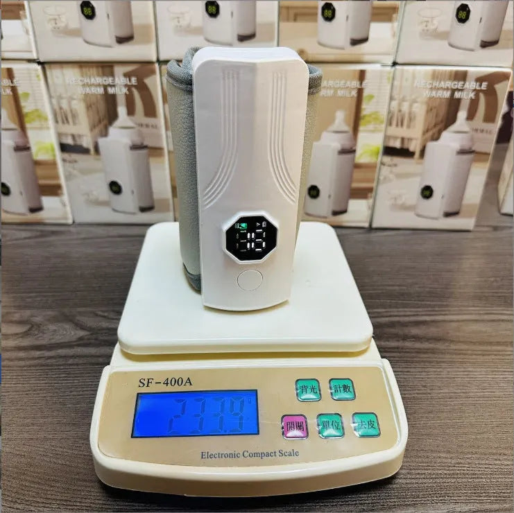 Grey and white electric milk warmer for car use with 12V charger plug.