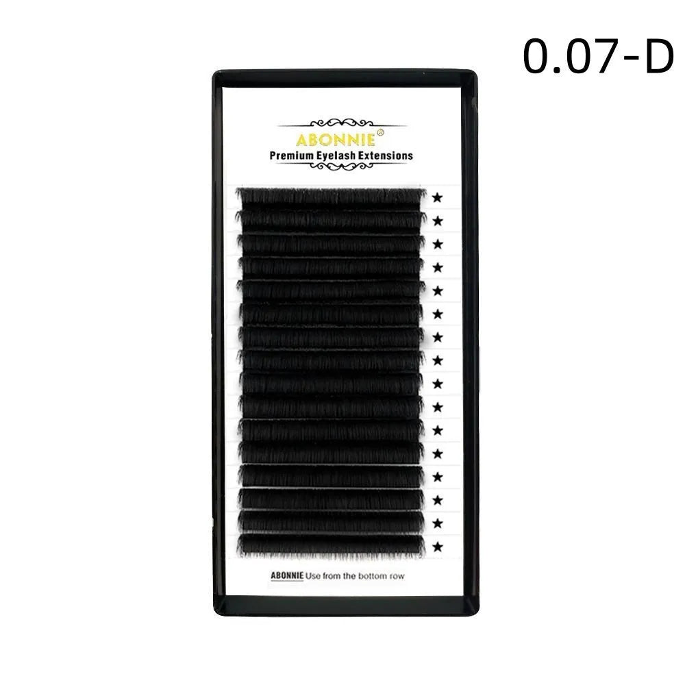 Pair of 16-row dense false eyelashes made from mink hair, showing matte round wool texture on a clear band.