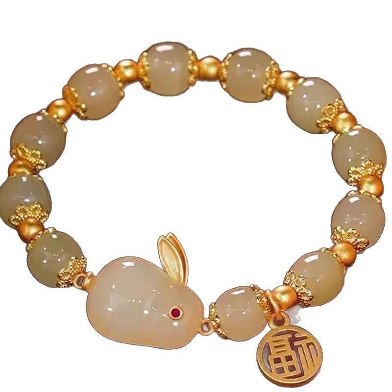 Handmade unisex glass beaded bracelet with rabbit charm on elastic cord.