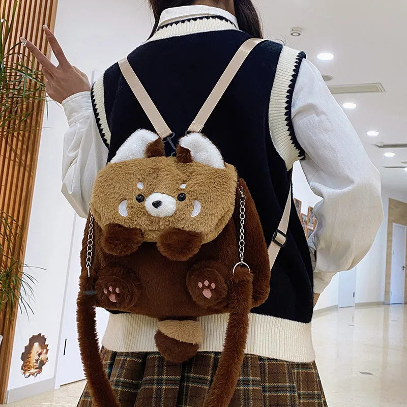 Brown coati plush bag doll cartoon backpack on display showing soft fabric and animal face design