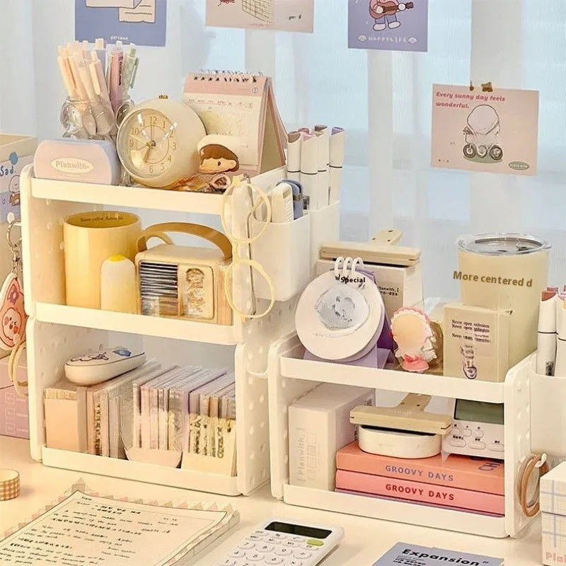 Beige plastic desktop wire-wrap board storage rack with three layers, two pen containers, and six hooks on a desk