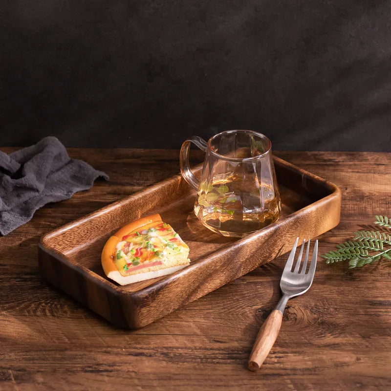 Walnut wooden fruit plate tray in rectangular size on a table surface.
