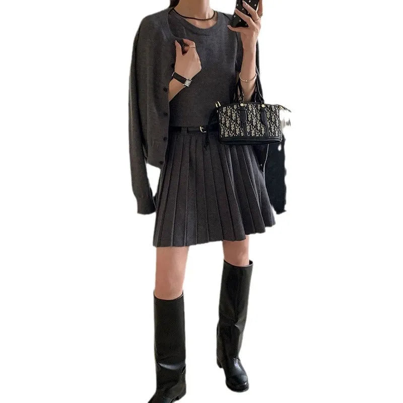 Grey knitted two-piece set with 3D pattern, featuring a belted vest skirt and long-sleeve cardigan.