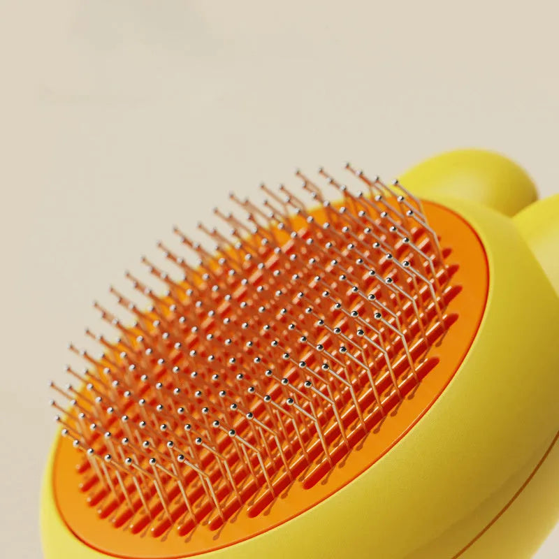 Self-cleaning pet grooming brush with release button in green, pink, purple or yellow colour options