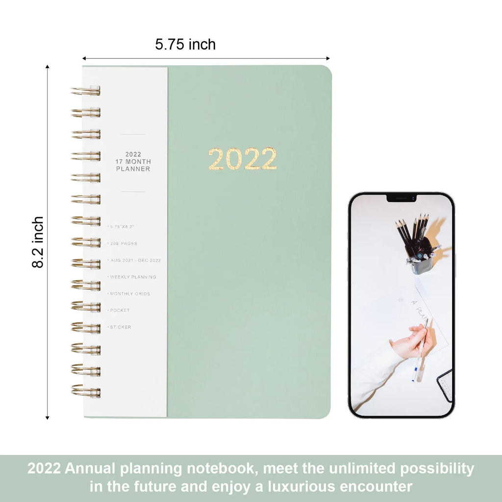 Green and blue 17-month 2022 student planner notebook with coil binding and pockets