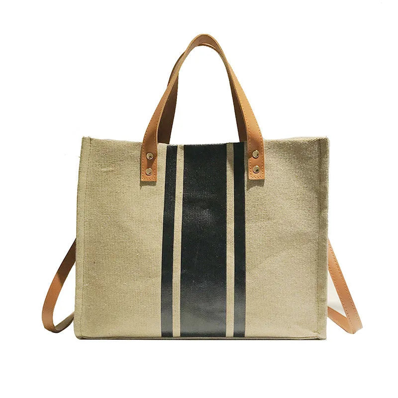 Canvas stripe tote bag in black and white with zipper closure, horizontal square shape, and 120cm shoulder strap