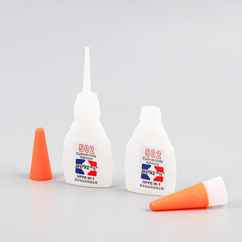 Tube of instant strong adhesive glue for shoe and leather repair with applicator tip.
