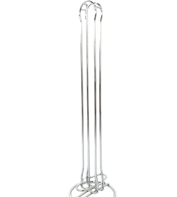 Black and silver wrought iron coffee capsule storage rack holding pods on shelves.