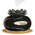 Pure black lotus-shaped aromatherapy humidifier with USB cable on a desk