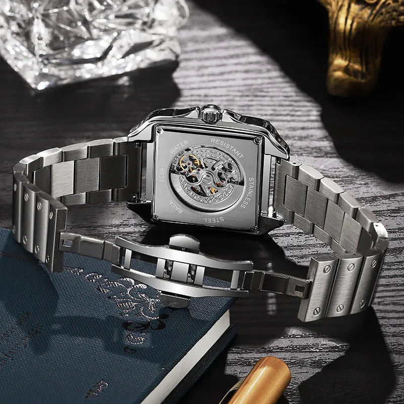 Men's square automatic watch with diamond studs on a black leather strap.