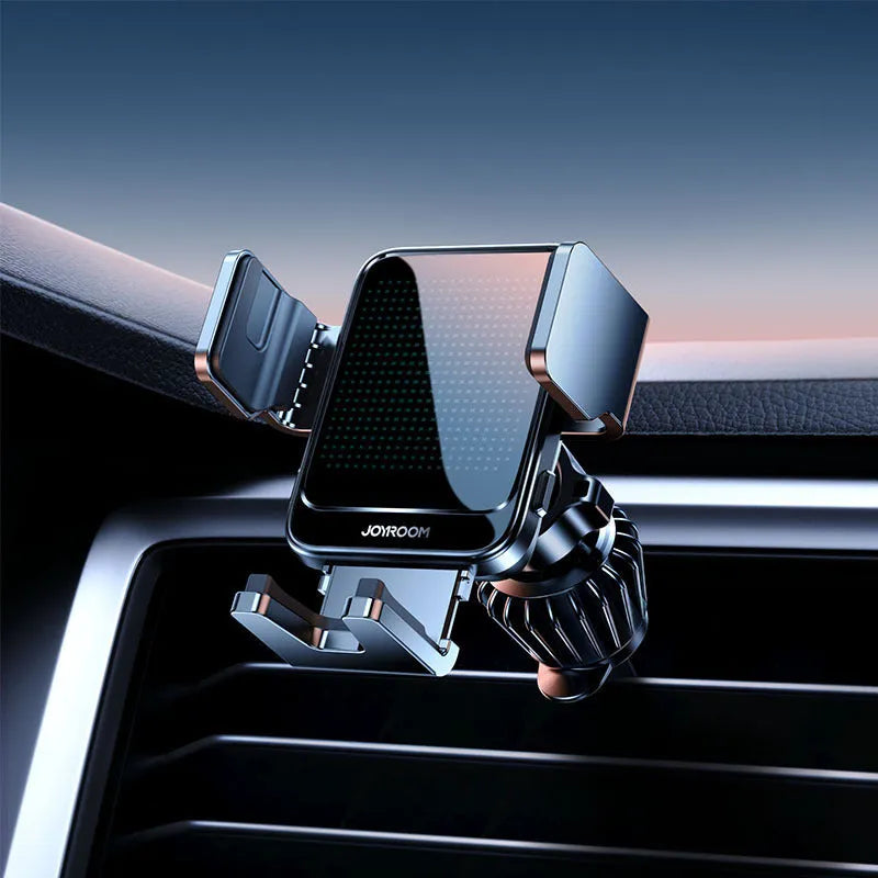 Black car wireless charging bracket mounted on an air vent, holding a mobile phone.