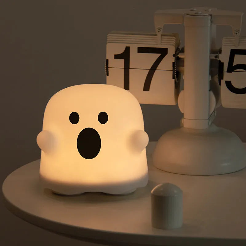 Silicone touch sensor LED night light on a bedside table showing soft glow.