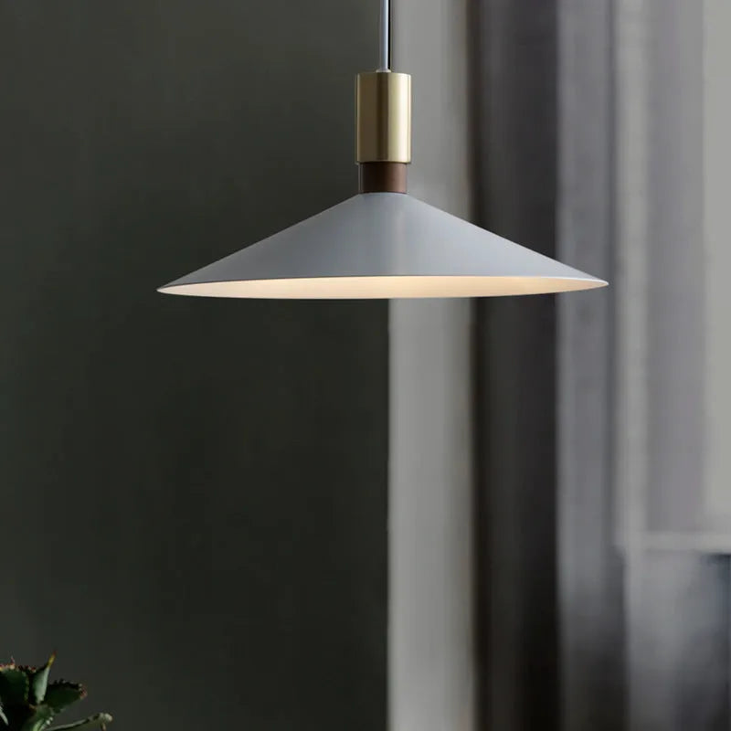 Minimalist round single-headed iron pendant lamp in black, shown in a dining setting.