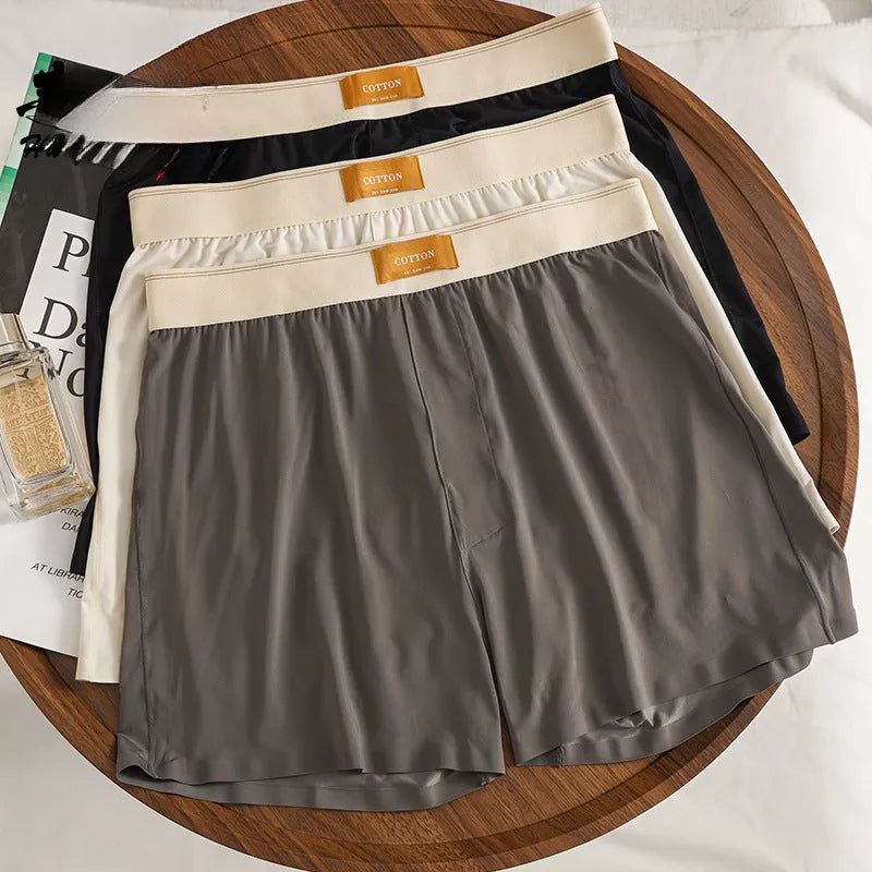 Men's loose fit ice silk underwear in solid colours showing mid-waist design and knitted fabric texture