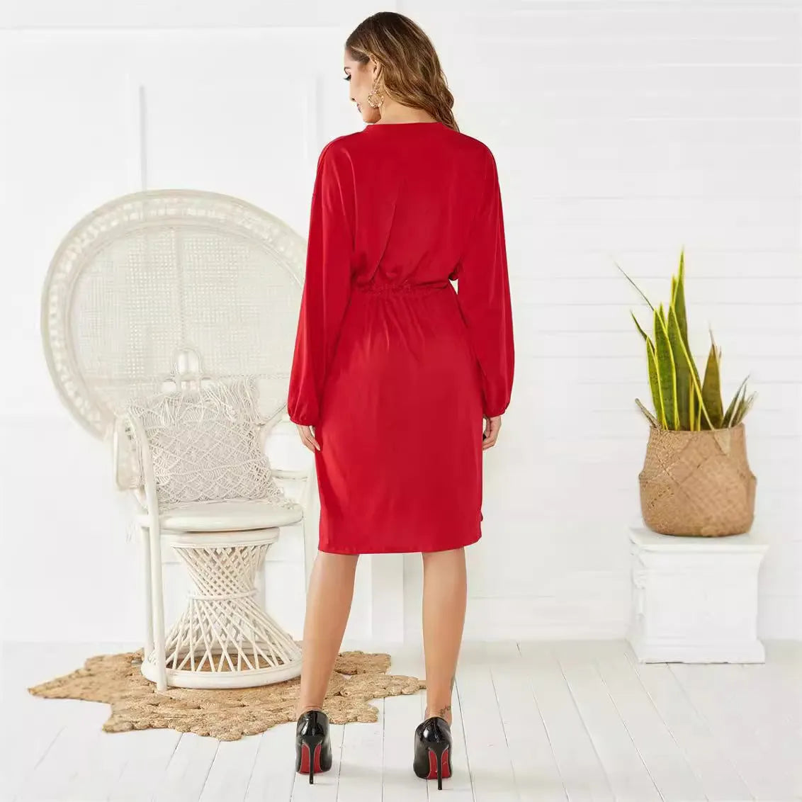 Black A-line midi dress with long sleeves, an elastic waist, and a matching cinching belt laid flat.