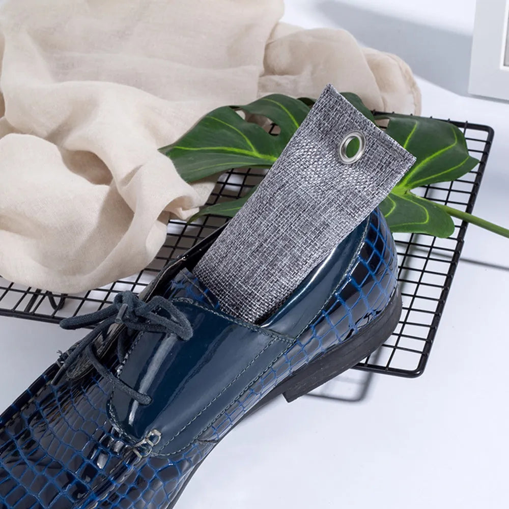 Black linen bag filled with bamboo charcoal for shoe and household odour removal.
