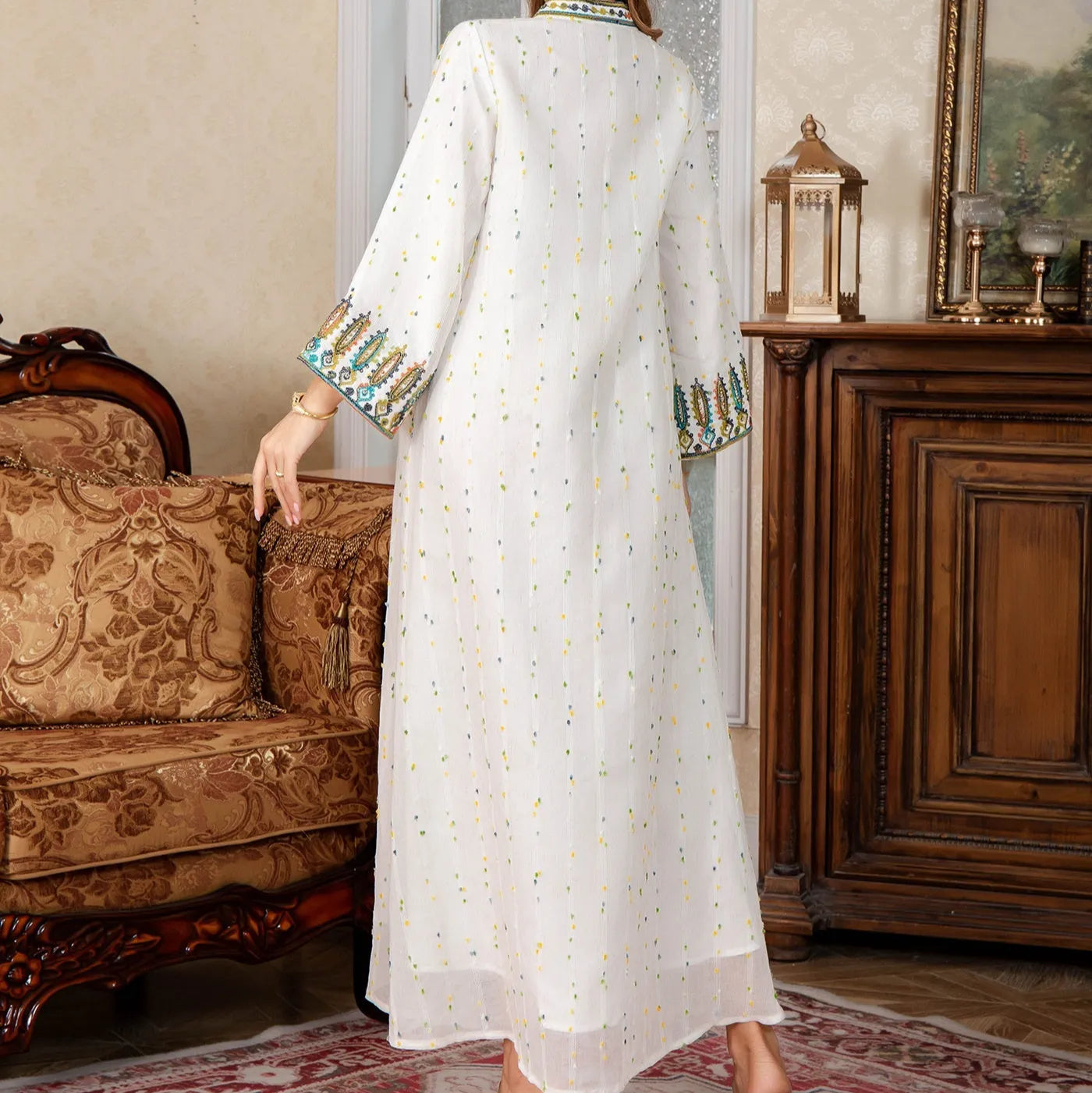 White long sleeve Arabic robe abaya on a hanger, full-length polyester maxi dress.