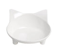 Shallow black melamine cat bowl with a wide rim and non-slip rubber base on a kitchen floor.