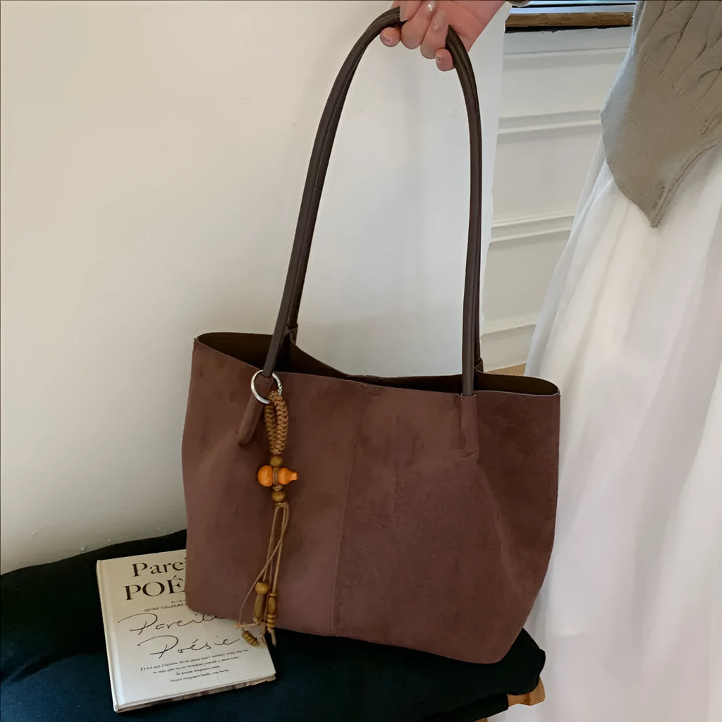 Large suede tote bag in brown with matching pendant, horizontal square shape, single shoulder strap, and retro styling