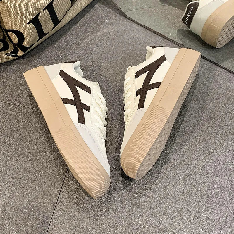 Low-top brown and blue casual board shoes with patent leather upper and flat rubber sole
