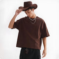 Man wearing a loose fit apricot coloured pure cotton short sleeve T-shirt.