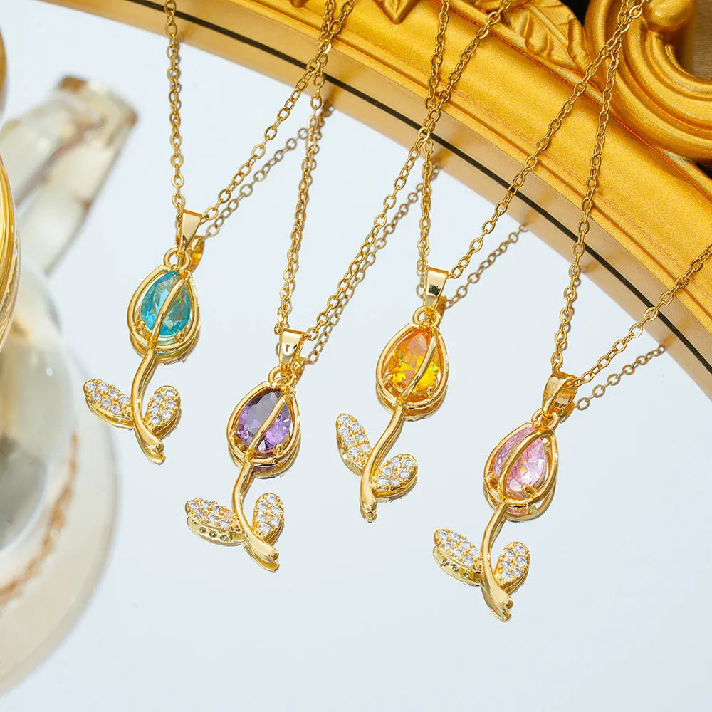 Gold tulip pendant necklace on an adjustable O-ring chain, showing non-fading electroplated finish.