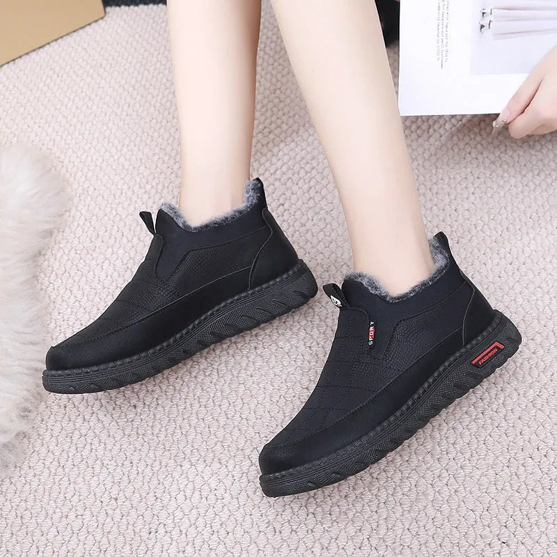 Women's black casual flat boots with a round toe and low-top synthetic leather upper.