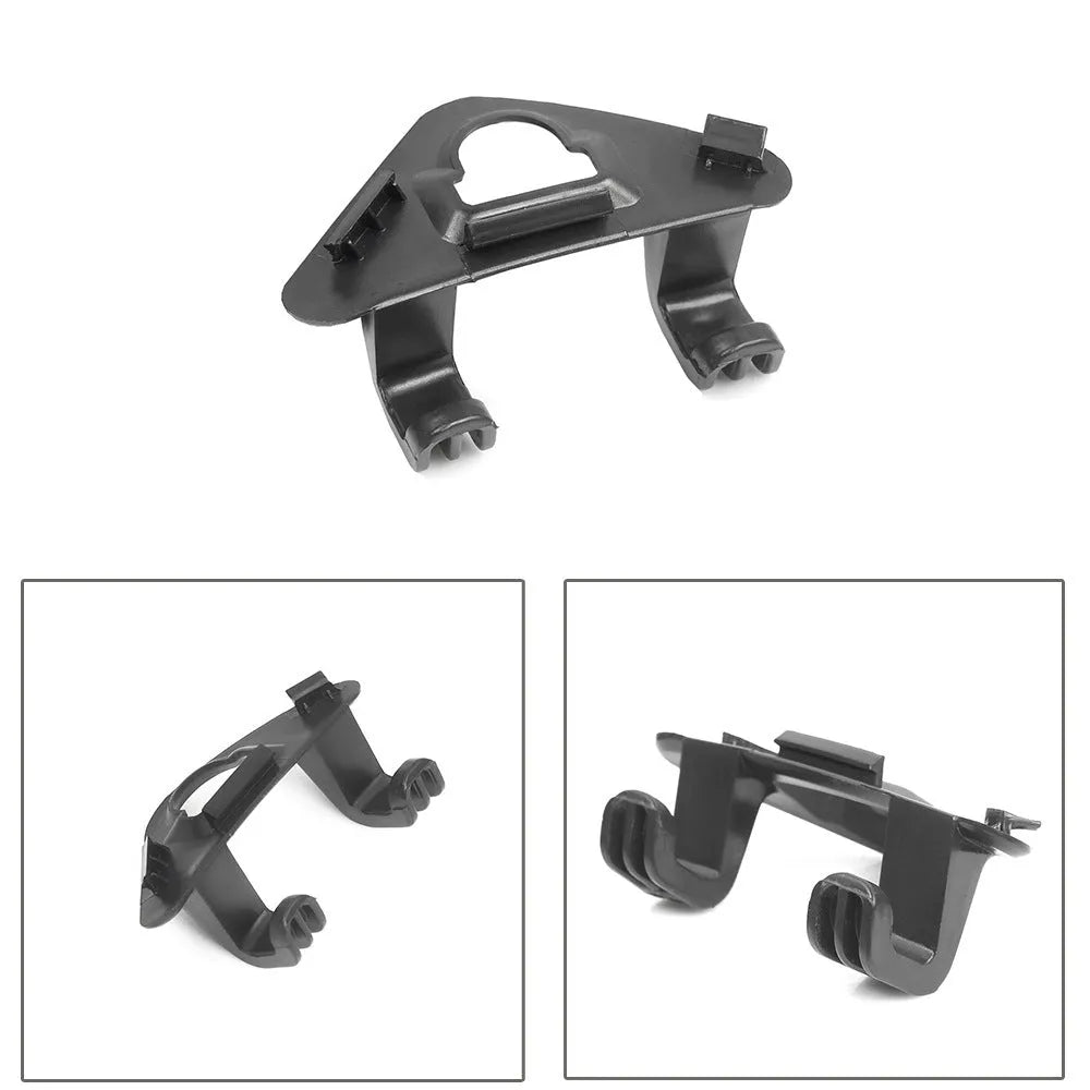 Single black ABS plastic trunk lid hook for Tesla Model Y on dark surface