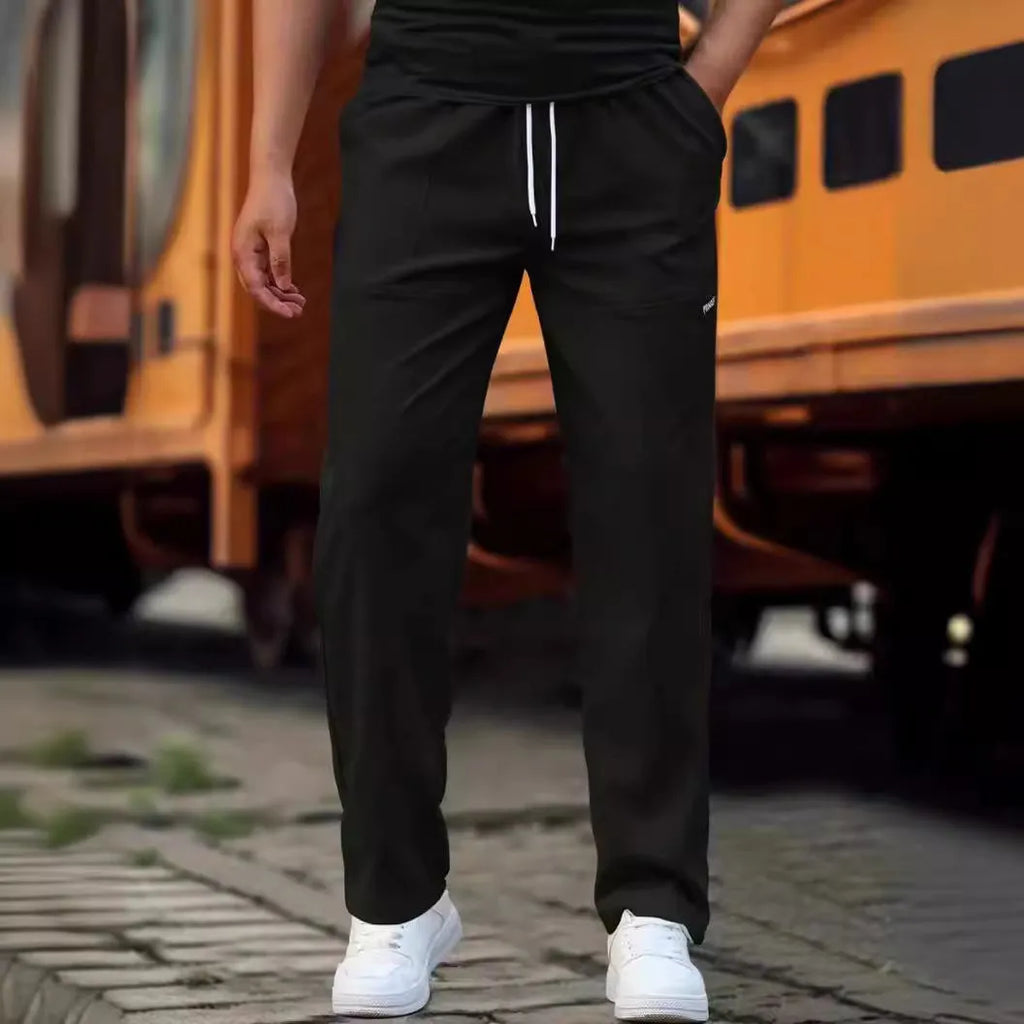 Men's light grey polyester trousers for spring and autumn casual wear, laid flat.