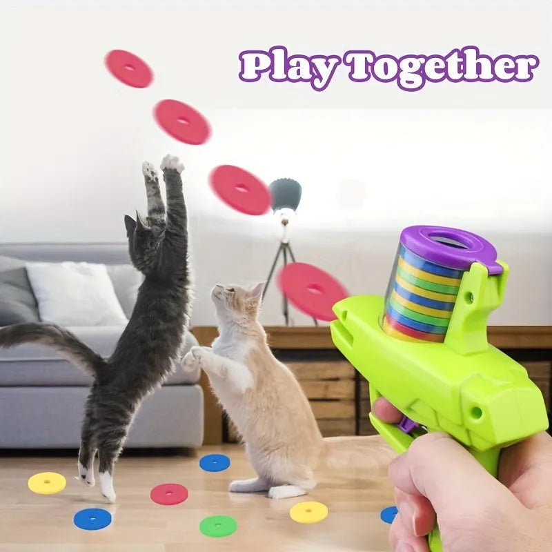 Green and purple battery-free interactive cat toy launcher with soft foam discs on a plain background
