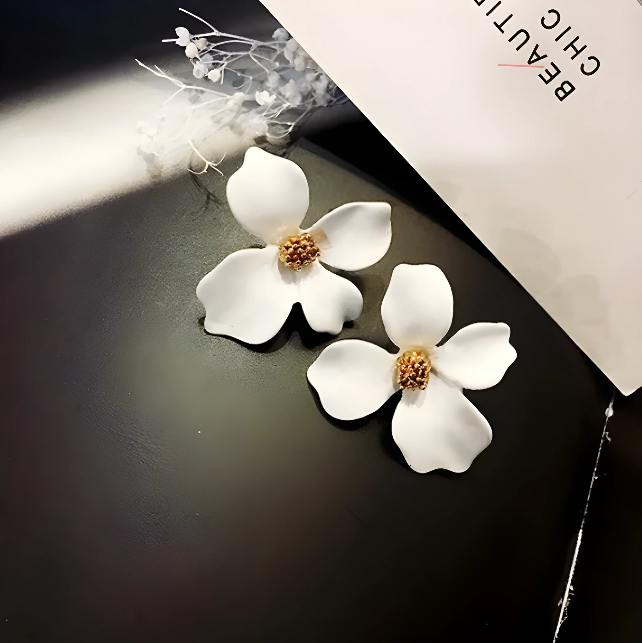 Flower-shaped stud earrings in pink and white colours with electroplated alloy construction