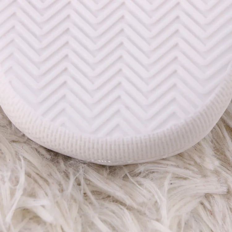 White fluffy cartoon slippers with a thick rubber non-slip sole and a toe holder strap.
