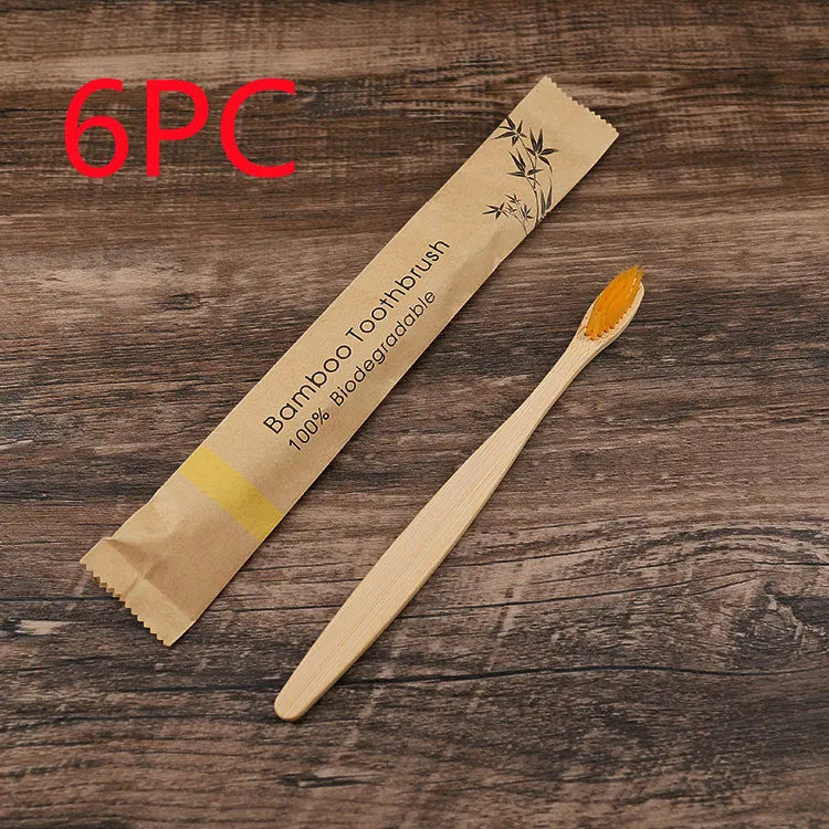 10 multi-coloured natural bamboo toothbrushes with soft charcoal bristles arranged on a white background