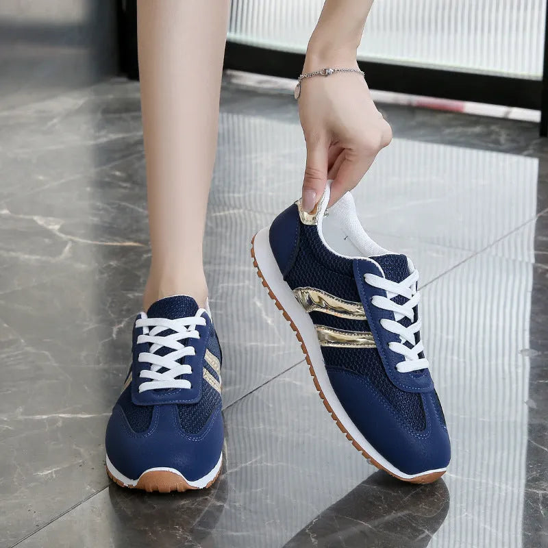 Blue women's casual sports shoes with cross shoulder straps and a white rubber sole.