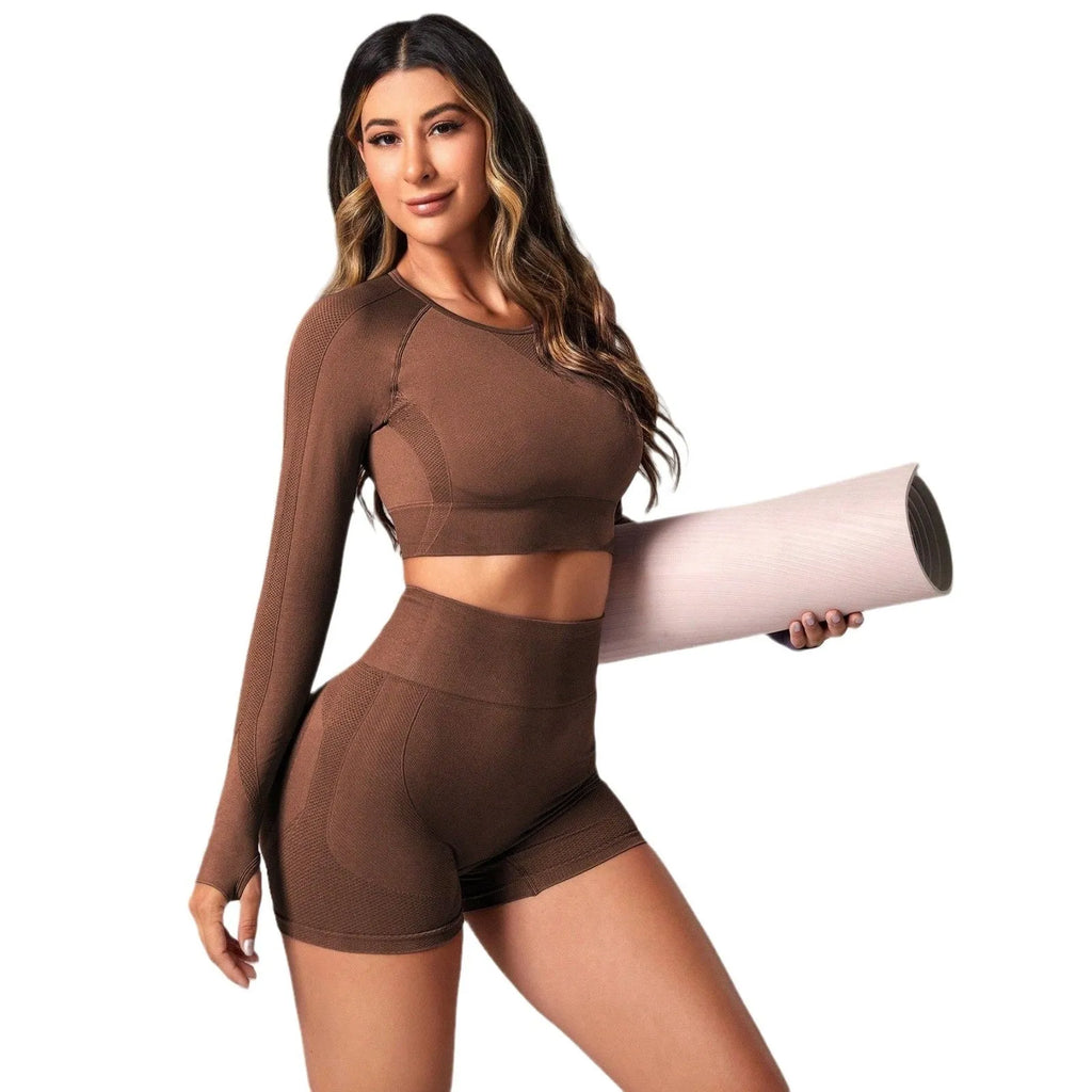 Women's high-waisted yoga suit set in black, featuring a long-sleeved top and tight leggings.