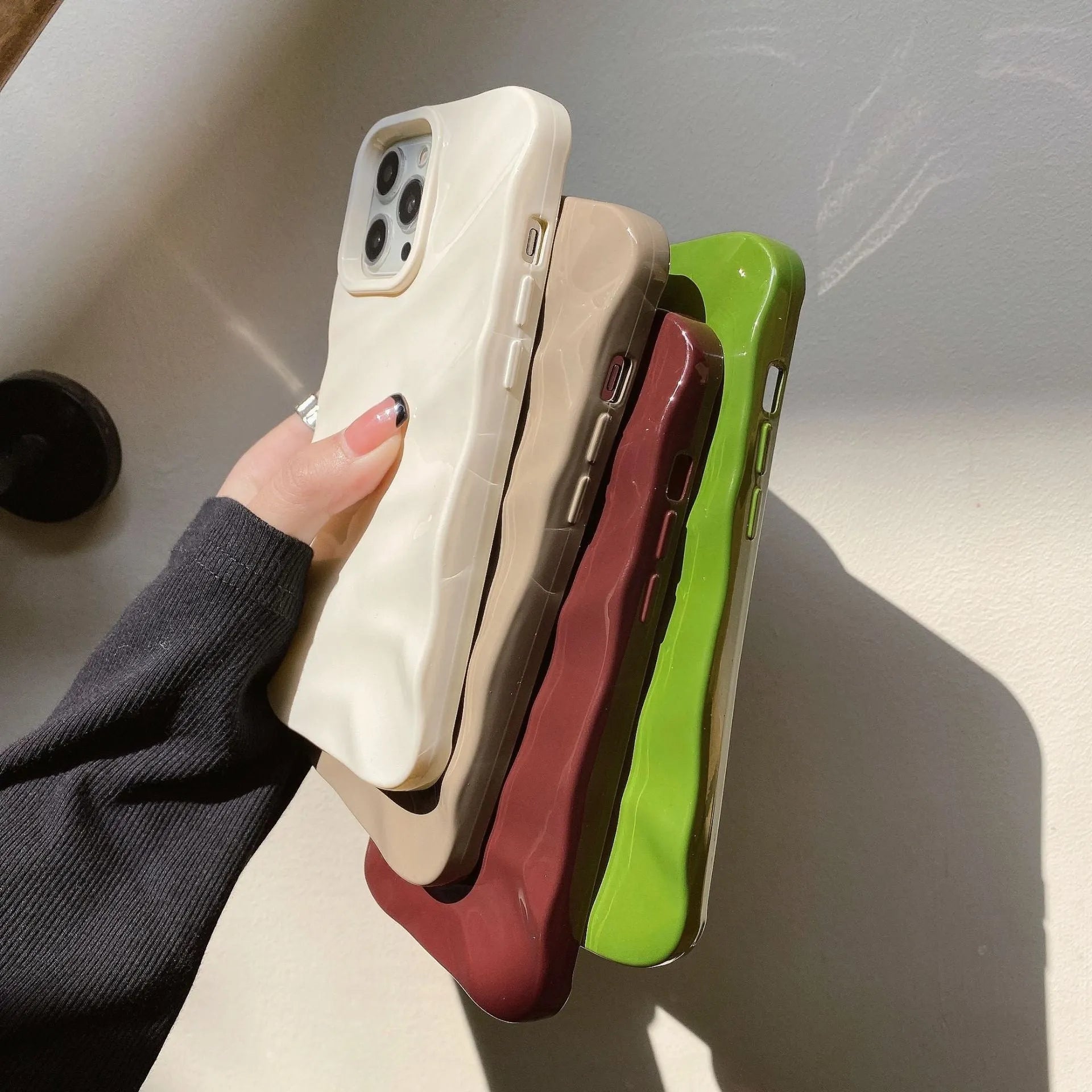 Soft wave pleated TPU phone case for Apple iPhone 17 in a selection of colours including electroplated gold and matte purple.