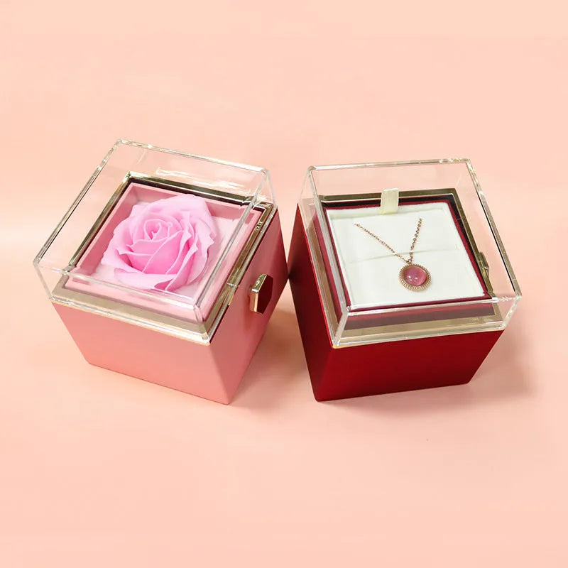 Rotating jewellery gift box with a preserved red rose under a clear acrylic dome.