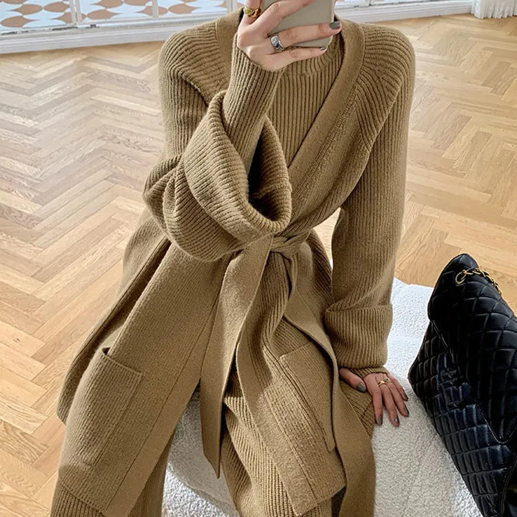 Women's apricot knitted three-piece set with wide-leg trousers, top, and long cardigan on a hanger.