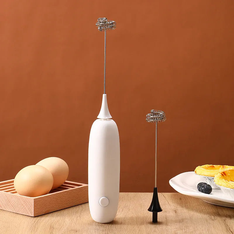 Black and white hand-held electric milk frother blender with modern design for coffee preparation