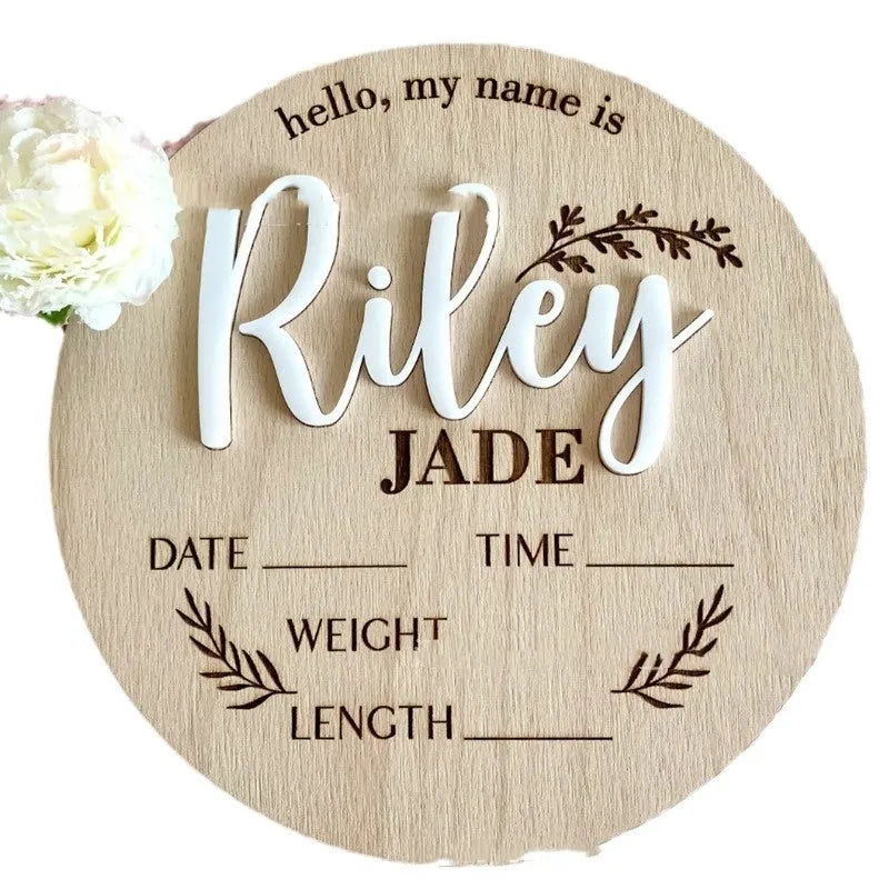 Square wooden newborn name plaque showing baby birth information and surname.
